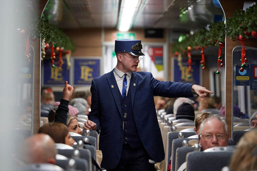 The conductor on board THE POLAR EXPRESS™ Train Ride 