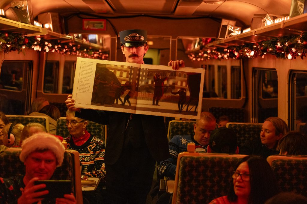 The Conductor holding The Polar Express book on board The Polar express Train Ride Edinburgh 