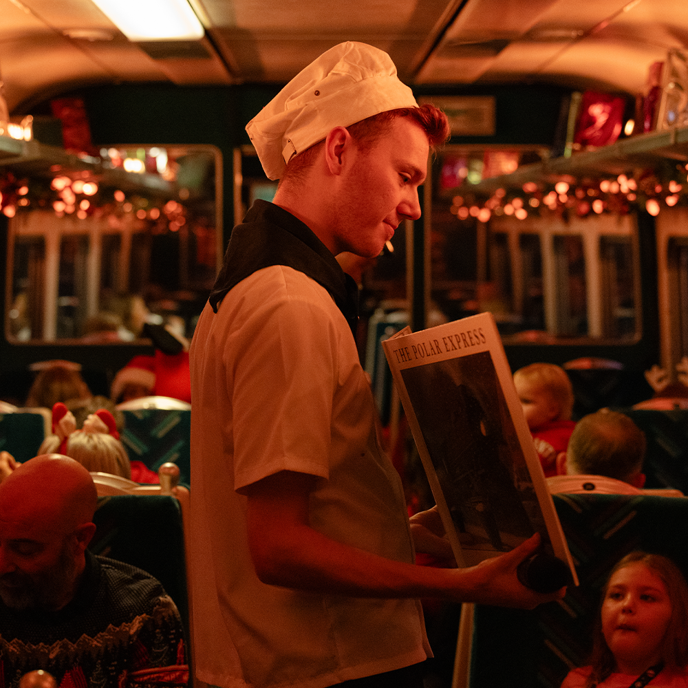 Chef with book on board THE POLAR EXPRESS™ Train Ride