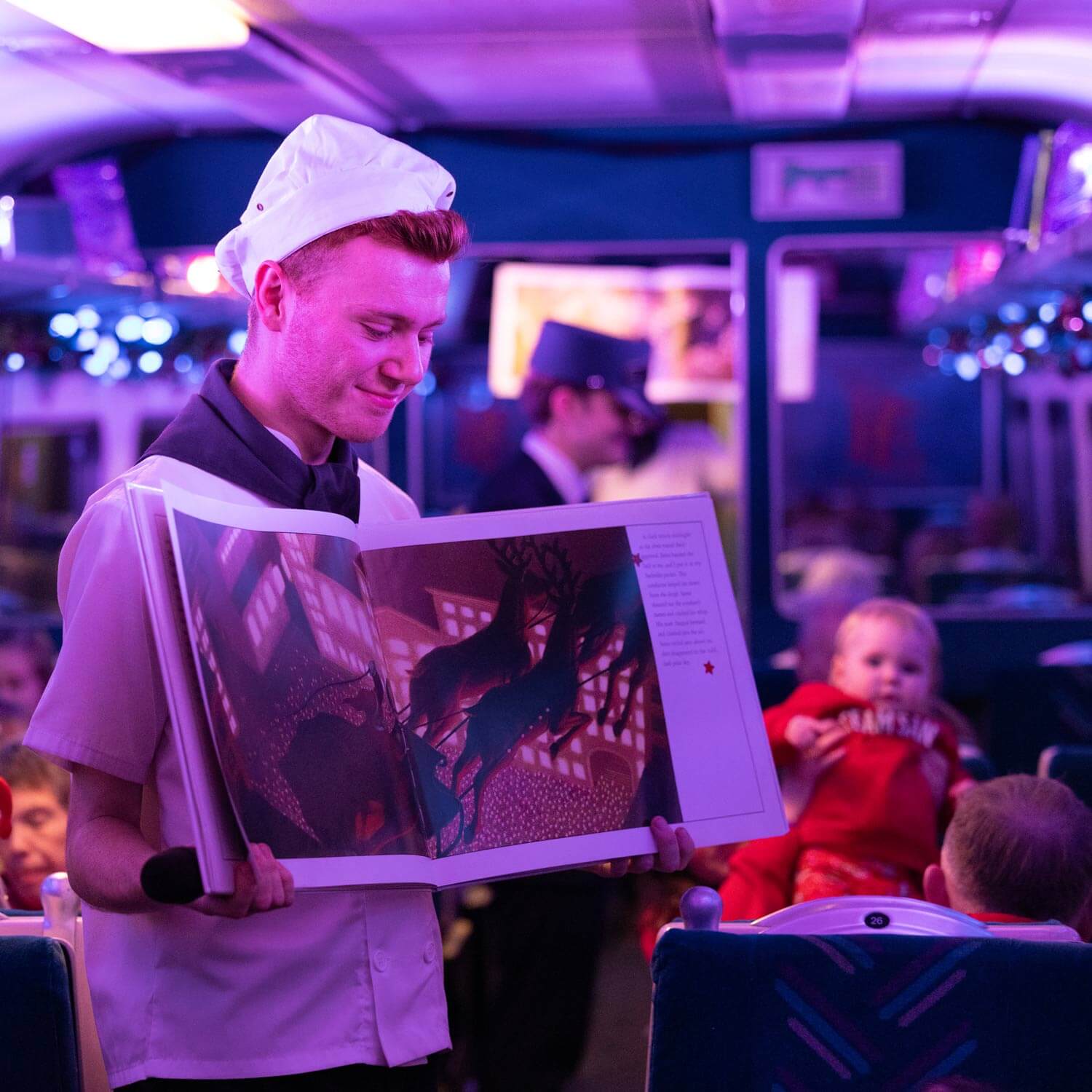 The conductor clipping tickets on THE POLAR EXPRESS™ Train Ride London